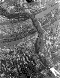 B/W aerial photograph of Harrisburg, Pennsylvania (scale=1:100,000).></a><BR> Harrisburg (Scale = 1:100,000)</CENTER> <P> The number in the upper left corner of this b & w photo of Harrisburg is the date; on the right is the Mission number; and in center is a number denoting the flight line and particular photo within that line. Individual fields, smaller rivers, bridges, and roads are easily picked out. <p><b><a name=