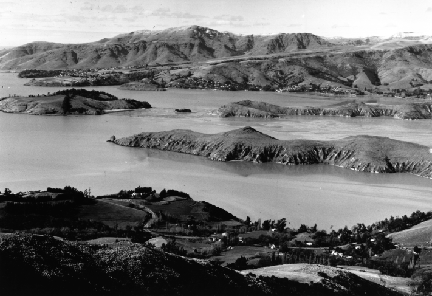 B/W high-oblique aerial photograph of Littleton Harbor on the South Island of New Zealand.