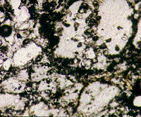 Color photomicrograph of grains of quartz in sandstone from the Sedan nuclear crater.
