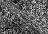 B/W Galileo image of the surface of Ganymede showing grooved surfaces (C).