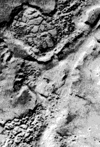 B/W image showing outflow features juxtaposed to chaotic terrain on the surface of Mars.